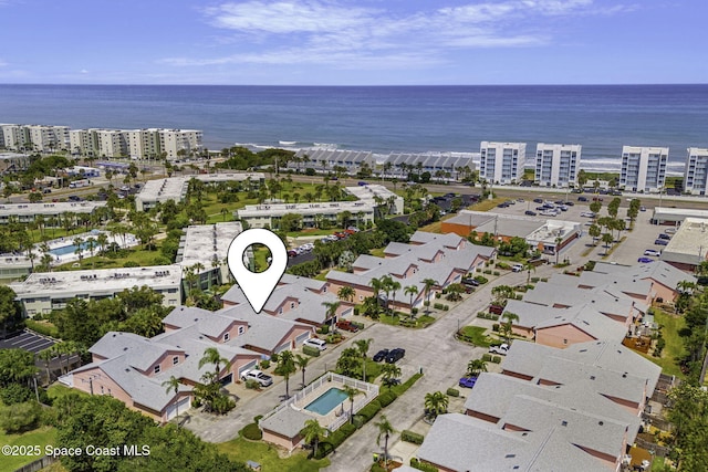 drone / aerial view with a city view and a water view
