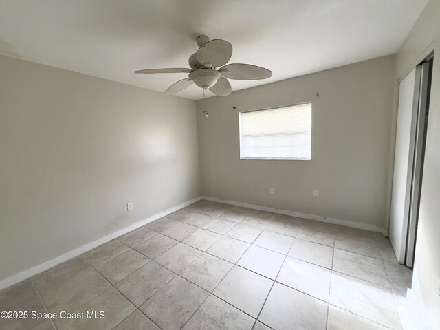 151 Ulster Ln, Melbourne, FL 32935 - empty room with light tile patterned floors, baseboards, and ceiling fan