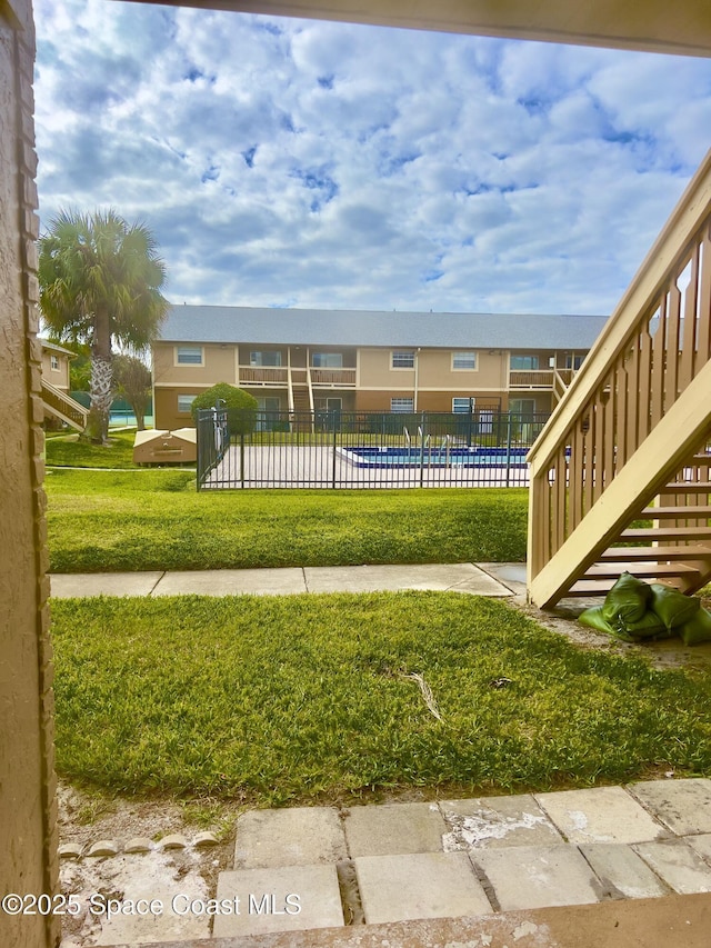 151 Ulster Ln, Melbourne, FL 32935 - view of home's community featuring a lawn, fence, and a pool