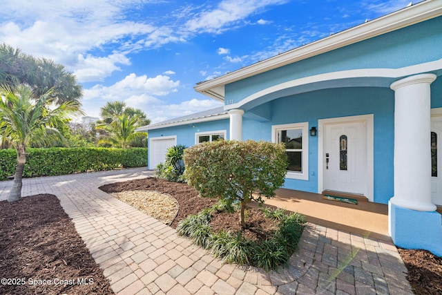 131 Harding Avenue 131& 129, Cocoa Beach, FL 32931 - property entrance with a garage and stucco siding