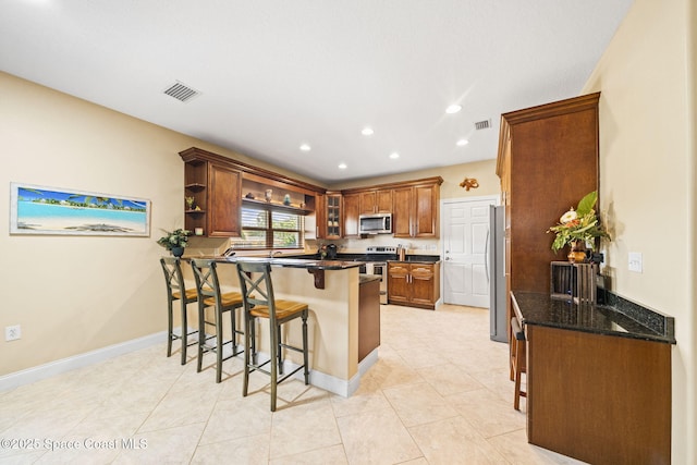 131 Harding Avenue 131& 129, Cocoa Beach, FL 32931 - kitchen featuring stainless steel appliances, a kitchen breakfast bar, a peninsula, open shelves, and recessed lighting