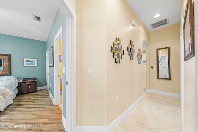 131 Harding Avenue 131& 129, Cocoa Beach, FL 32931 - hallway featuring lofted ceiling, arched walkways, and baseboards