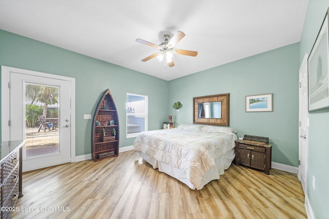 131 Harding Avenue 131& 129, Cocoa Beach, FL 32931 - bedroom featuring access to exterior, wood finished floors, baseboards, and a ceiling fan
