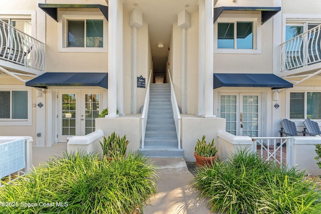 8600 Ridgewood Ave Unit 1211, Cape Canaveral, FL 32920 - view of exterior entry with french doors and stucco siding