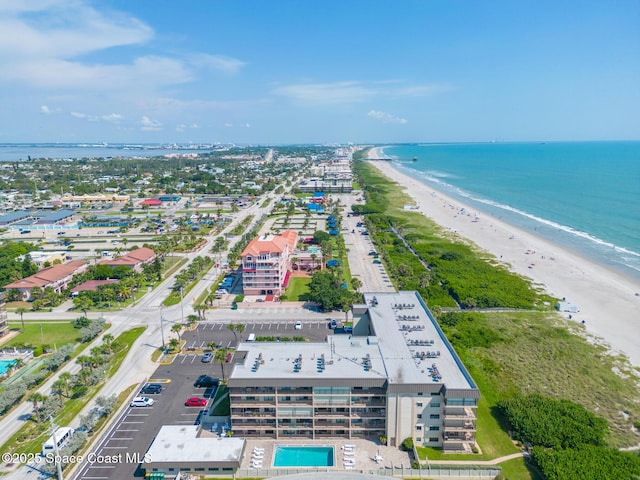 birds eye view of property featuring a beach view and a water view