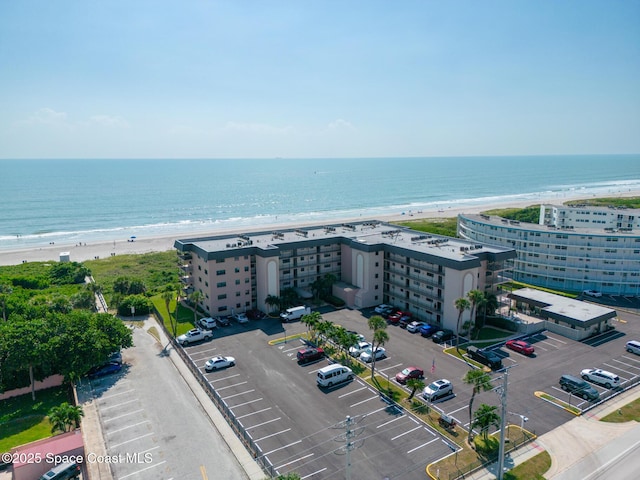 birds eye view of property featuring a view of the beach and a water view
