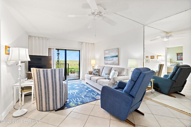 living area featuring ceiling fan and light tile patterned flooring