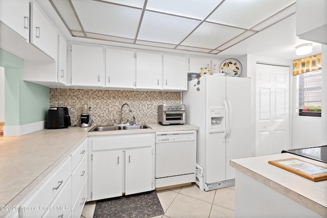 kitchen with a sink, white cabinets, white appliances, and light countertops