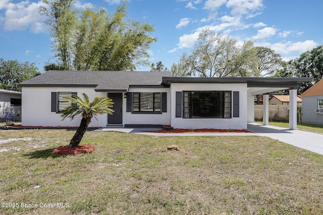 1107 Woodlawn Rd, Rockledge, FL 32955 - single story home featuring fence, a front lawn, concrete driveway, and an attached carport