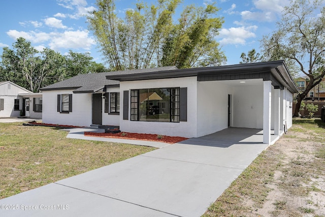 1107 Woodlawn Rd, Rockledge, FL 32955 - view of front facade with a carport, a front lawn, and driveway