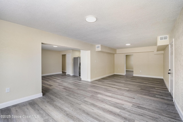 1107 Woodlawn Rd, Rockledge, FL 32955 - below grade area with baseboards, visible vents, wood finished floors, and a textured ceiling