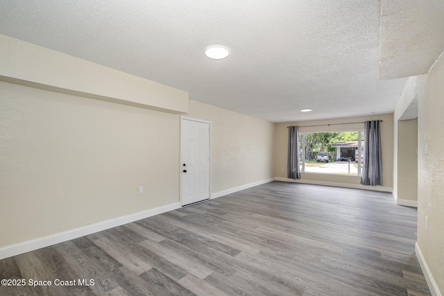 1107 Woodlawn Rd, Rockledge, FL 32955 - empty room with a textured ceiling, wood finished floors, and baseboards