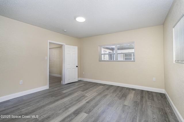 1107 Woodlawn Rd, Rockledge, FL 32955 - unfurnished room with a textured ceiling, wood finished floors, and baseboards