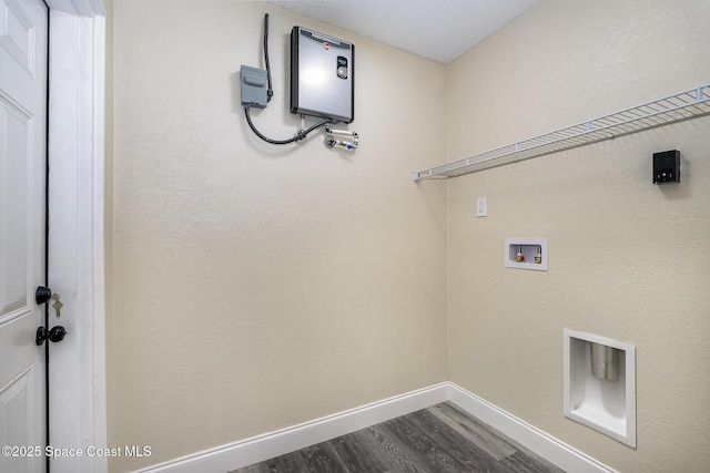 1107 Woodlawn Rd, Rockledge, FL 32955 - laundry area featuring dark wood-style floors, baseboards, washer hookup, and laundry area