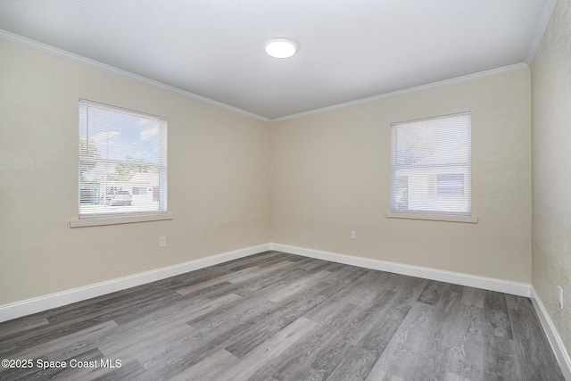 1107 Woodlawn Rd, Rockledge, FL 32955 - empty room featuring wood finished floors, a healthy amount of sunlight, ornamental molding, and baseboards