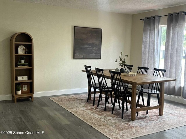 1107 Woodlawn Rd, Rockledge, FL 32955 - dining space featuring a textured ceiling, wood finished floors, and baseboards