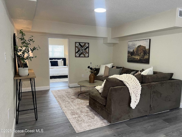 1107 Woodlawn Rd, Rockledge, FL 32955 - living area featuring a textured ceiling, visible vents, wood finished floors, and baseboards