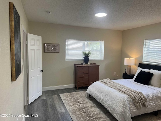 1107 Woodlawn Rd, Rockledge, FL 32955 - bedroom featuring dark wood-type flooring, baseboards, and a textured ceiling