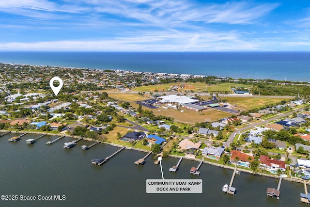 aerial view of property's location with a nearby body of water and nearby suburban area