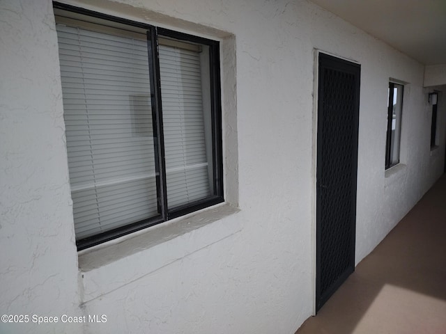 doorway to property with stucco siding