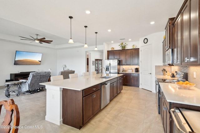 2241 Caravan Pl, Melbourne, FL 32940 - kitchen with appliances with stainless steel finishes, decorative backsplash, open floor plan, light tile patterned flooring, and recessed lighting