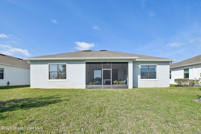 2241 Caravan Pl, Melbourne, FL 32940 - rear view of property featuring stucco siding, a yard, and a sunroom