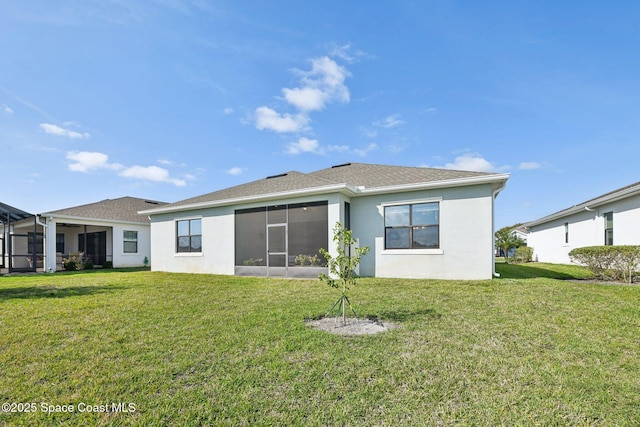 2241 Caravan Pl, Melbourne, FL 32940 - rear view of house featuring a yard, stucco siding, and a sunroom