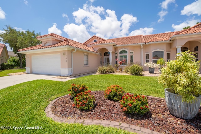 mediterranean / spanish house featuring concrete driveway, a tiled roof, a front yard, an attached garage, and stucco siding
