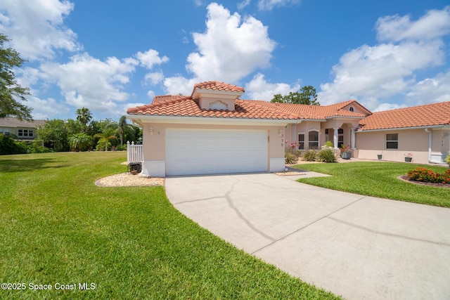 mediterranean / spanish home featuring a front lawn, stucco siding, a tiled roof, concrete driveway, and an attached garage