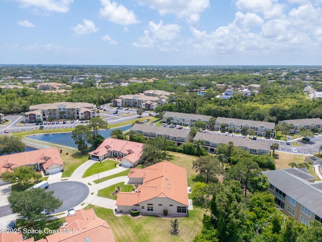 birds eye view of property featuring a residential view and a water view