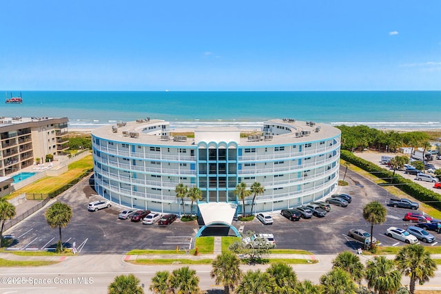 drone / aerial view of a large body of water and apartment complex / building