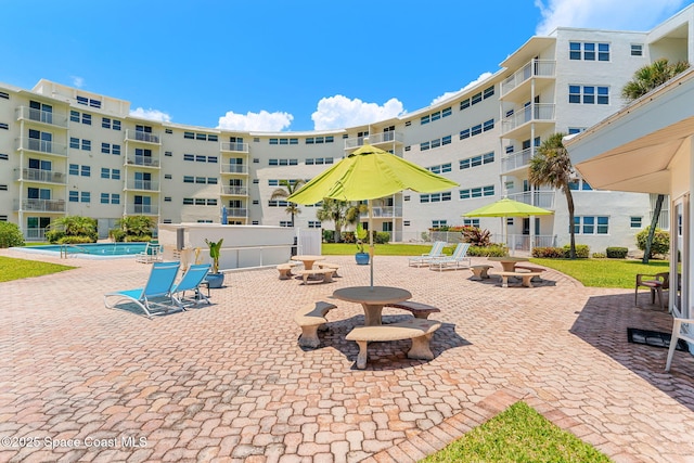 view of home's community featuring a pool and a patio area
