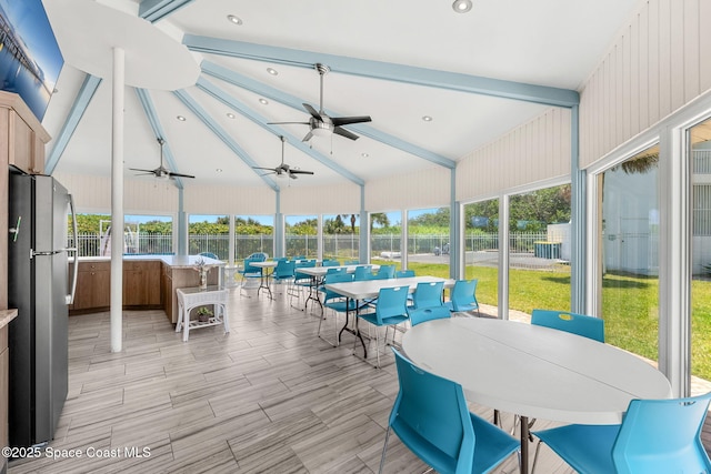 sunroom featuring outdoor dining area, ceiling fan, and healthy amount of natural light