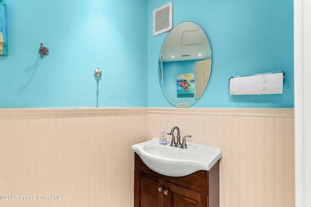 bathroom featuring a wainscoted wall and vanity