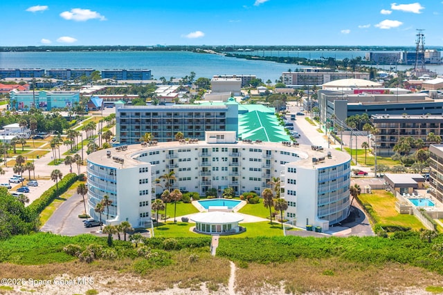 aerial view of apartment complex and a nearby body of water