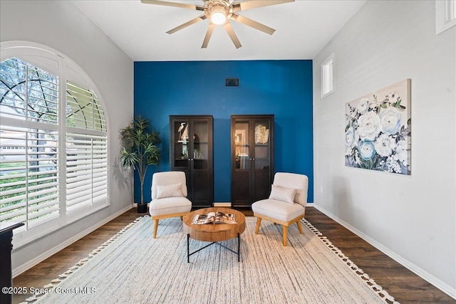 117 Windward Way, Indian Harbour Beach, FL 32937 - sitting room with wood finished floors, a healthy amount of sunlight, a ceiling fan, and baseboards