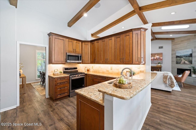 117 Windward Way, Indian Harbour Beach, FL 32937 - kitchen featuring light stone countertops, stainless steel appliances, lofted ceiling with beams, and a sink