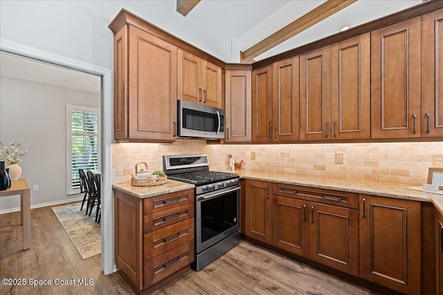 117 Windward Way, Indian Harbour Beach, FL 32937 - kitchen with appliances with stainless steel finishes, wood finished floors, light stone counters, and tasteful backsplash