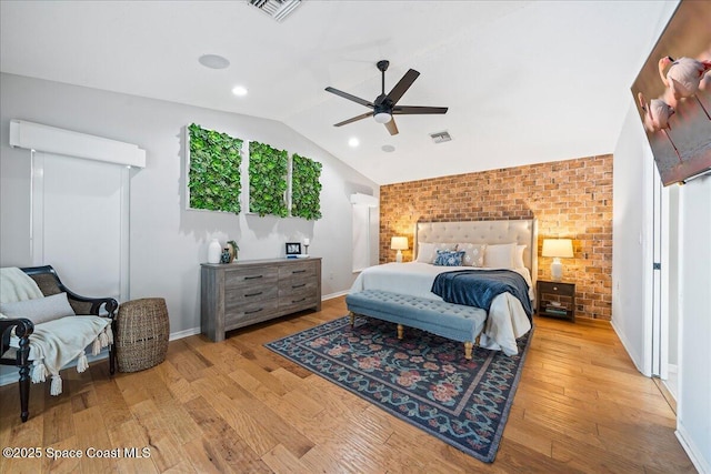 117 Windward Way, Indian Harbour Beach, FL 32937 - bedroom with wood finished floors, visible vents, brick wall, and vaulted ceiling
