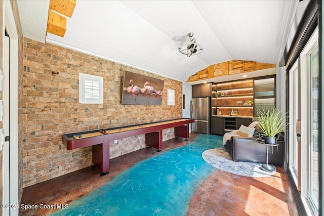 117 Windward Way, Indian Harbour Beach, FL 32937 - interior space featuring lofted ceiling, concrete floors, and brick wall