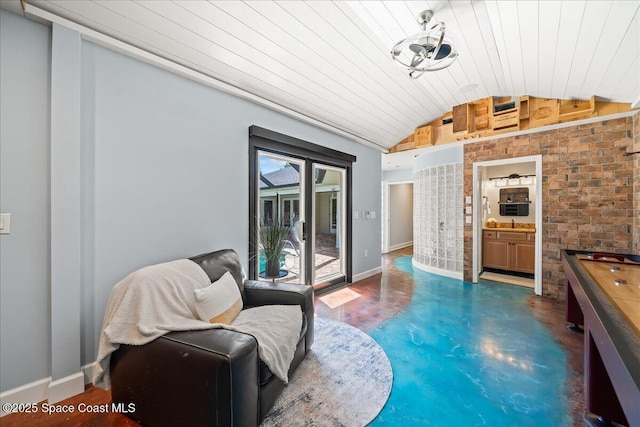 117 Windward Way, Indian Harbour Beach, FL 32937 - sitting room featuring wood ceiling, finished concrete floors, baseboards, brick wall, and vaulted ceiling