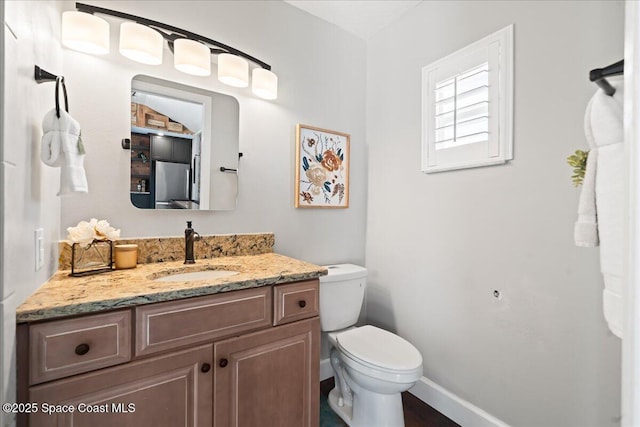 117 Windward Way, Indian Harbour Beach, FL 32937 - bathroom featuring toilet, vanity, and baseboards