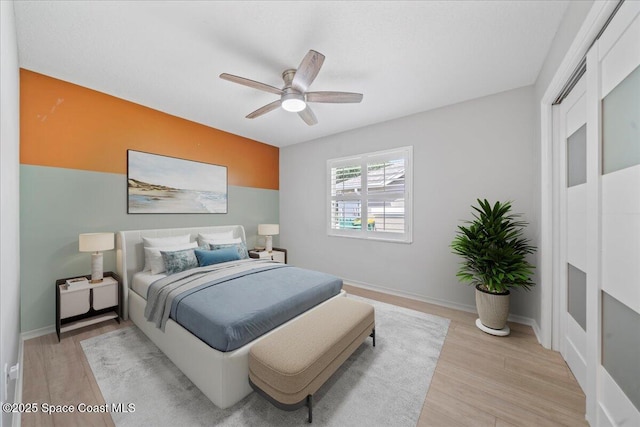 117 Windward Way, Indian Harbour Beach, FL 32937 - bedroom featuring a ceiling fan, light wood-style flooring, and baseboards