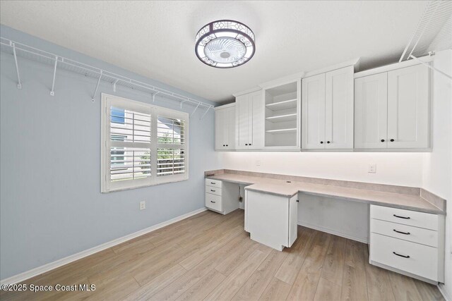 117 Windward Way, Indian Harbour Beach, FL 32937 - unfurnished office with baseboards, light wood-type flooring, and built in study area