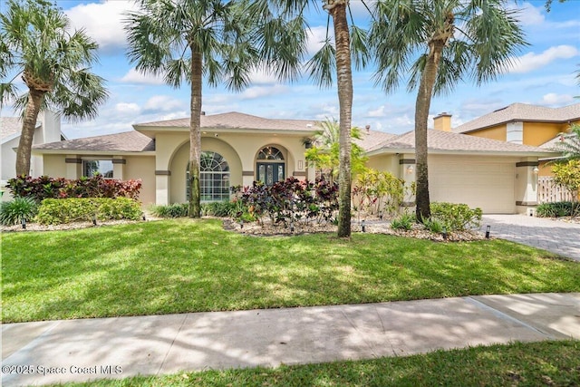 117 Windward Way, Indian Harbour Beach, FL 32937 - view of front facade featuring a garage, a chimney, stucco siding, and a front yard