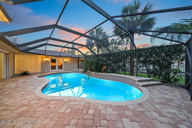 117 Windward Way, Indian Harbour Beach, FL 32937 - pool at dusk with an outdoor pool, a patio, and glass enclosure