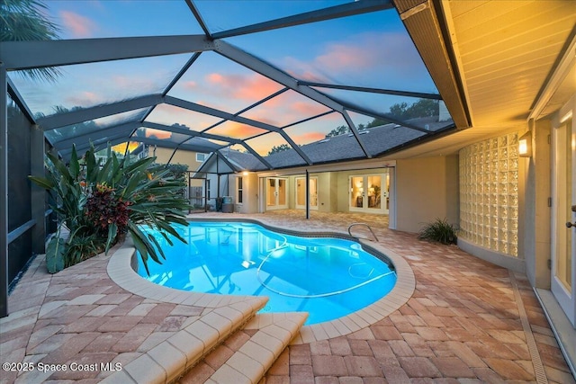 117 Windward Way, Indian Harbour Beach, FL 32937 - pool at dusk with a lanai, french doors, a patio area, and an outdoor pool