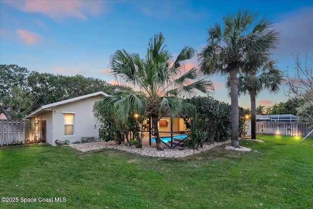 117 Windward Way, Indian Harbour Beach, FL 32937 - back of house with a lawn, a fenced in pool, stucco siding, and a fenced backyard