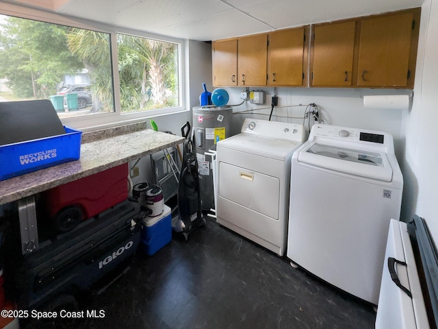 laundry room with washing machine and dryer, water heater, and cabinet space