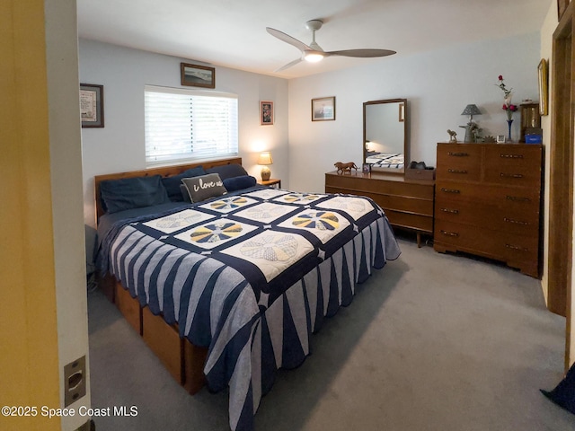 bedroom featuring light carpet and a ceiling fan